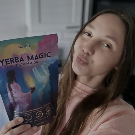 MindGlow customer holding Peach Mango Yerba Mate pouch
